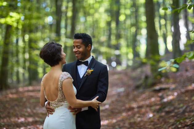 bride and groom hugging in the woods