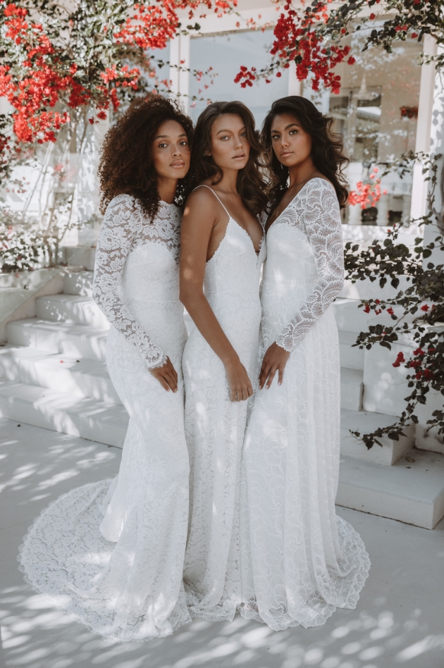 Three models in a group two with long sleeved dresses