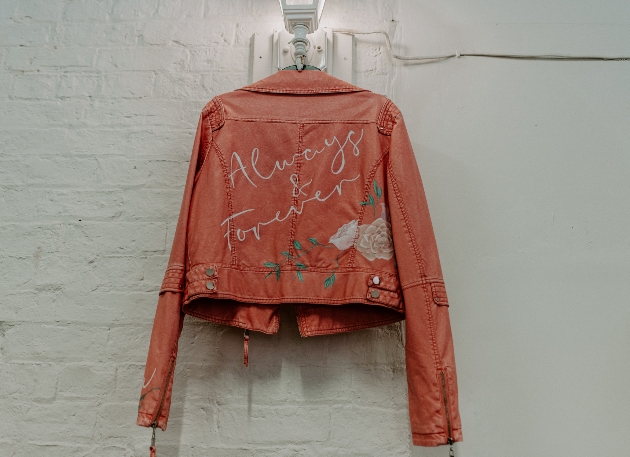 orange leather jacket with writing on the back 