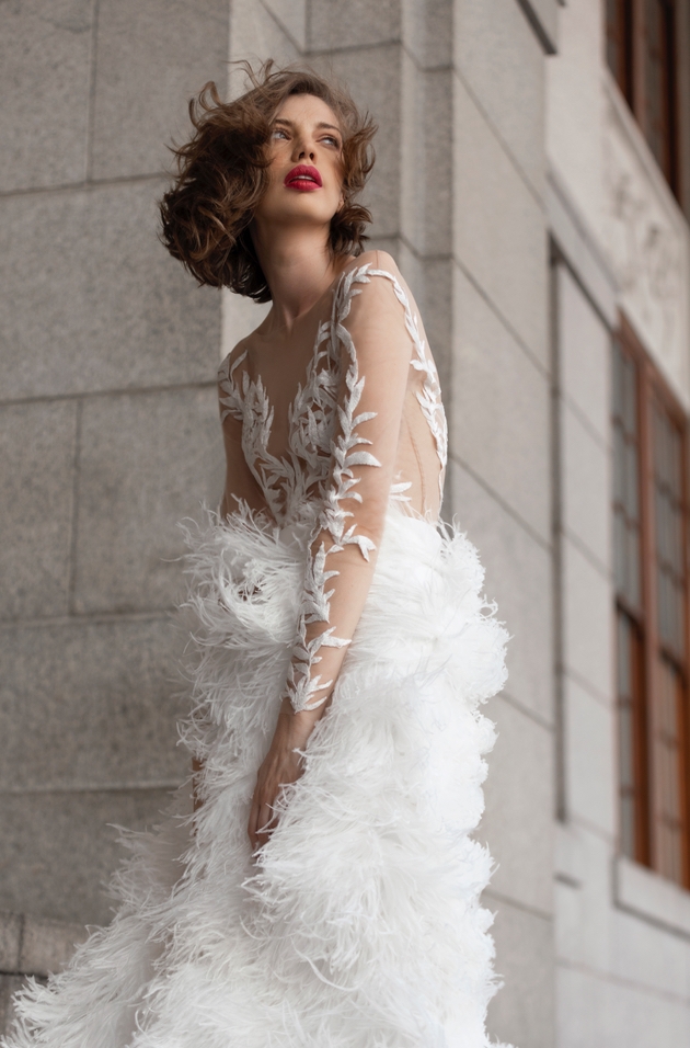 Model wearing white feather bridal dress