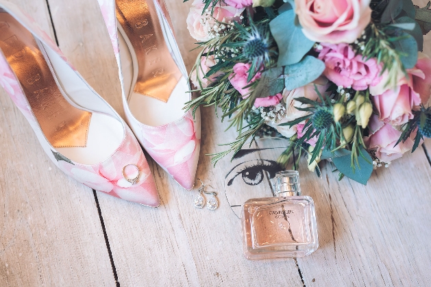 Bride's shoes, rings, perfume and bouquet