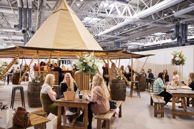food area with tents and tables inside exhibition centre 