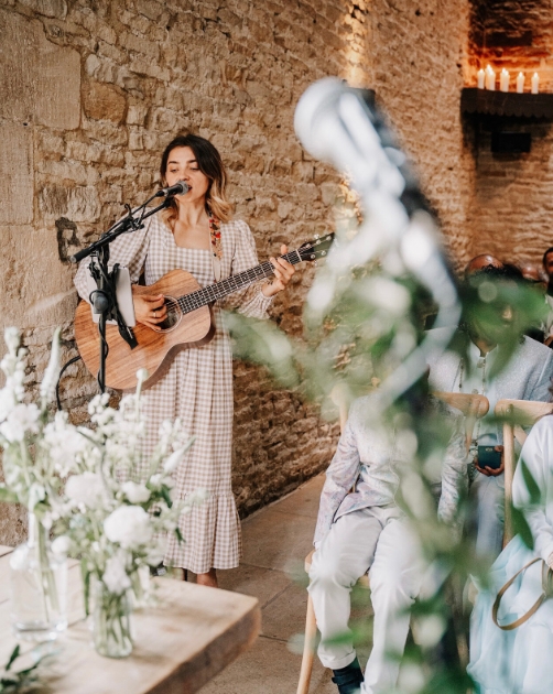 female singer with a guitar at a wedding
